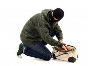 7613217-thief-in-black-balaclava-with-stolen-bag