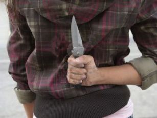 4926158-young-woman-holding-knife-behind-back
