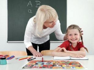 10272587-teacher-teaching-6-year-old-student-in-classroom