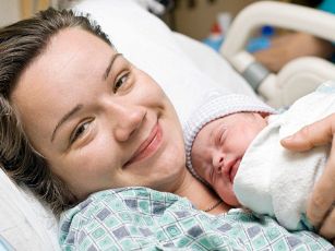newborn-baby-and-smiling-mom resized