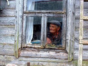 1637007-988294-the-old-man-in-the-window-of-an-old-house