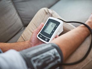 923man-measuring-his-own-blood-pressure-with-band-and-monitor